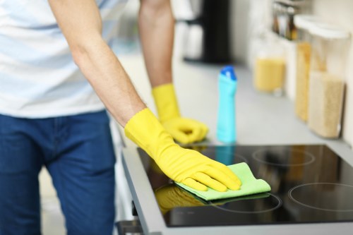 Professional oven cleaning team applying final safety checks and tidy finish